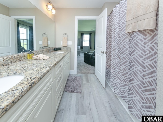 284 Old Swamp Rd, South Mills, NC 27976 - bathroom featuring connected bathroom, wood finished floors, double vanity, and curtained shower