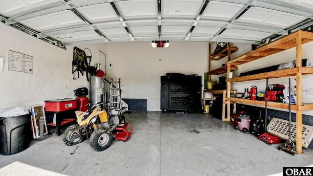 284 Old Swamp Rd, South Mills, NC 27976 - garage featuring a garage door opener, water heater, and a workshop area
