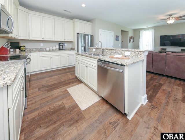 284 Old Swamp Rd, South Mills, NC 27976 - kitchen featuring appliances with stainless steel finishes, open floor plan, dark wood-style floors, white cabinets, and recessed lighting