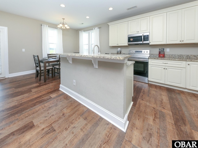 284 Old Swamp Rd, South Mills, NC 27976 - kitchen with appliances with stainless steel finishes, a chandelier, white cabinetry, light stone counters, and recessed lighting