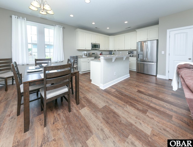 284 Old Swamp Rd, South Mills, NC 27976 - kitchen featuring appliances with stainless steel finishes, a chandelier, white cabinetry, an island with sink, and dark wood-style floors