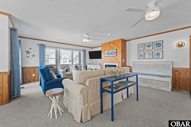 11 Pelican Watch Way Unit A/Lot11, Southern Shores, NC 27949 - living area with wooden walls, a wainscoted wall, ceiling fan, crown molding, and carpet floors