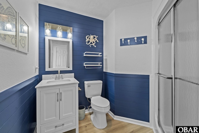 11 Pelican Watch Way Unit A/Lot11, Southern Shores, NC 27949 - full bathroom with a stall shower, toilet, wood finished floors, vanity, and wainscoting
