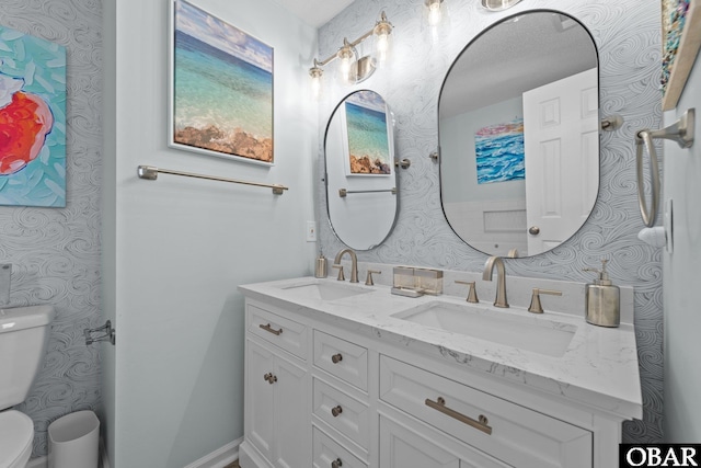 11 Pelican Watch Way Unit A/Lot11, Southern Shores, NC 27949 - bathroom featuring wallpapered walls, toilet, and double vanity