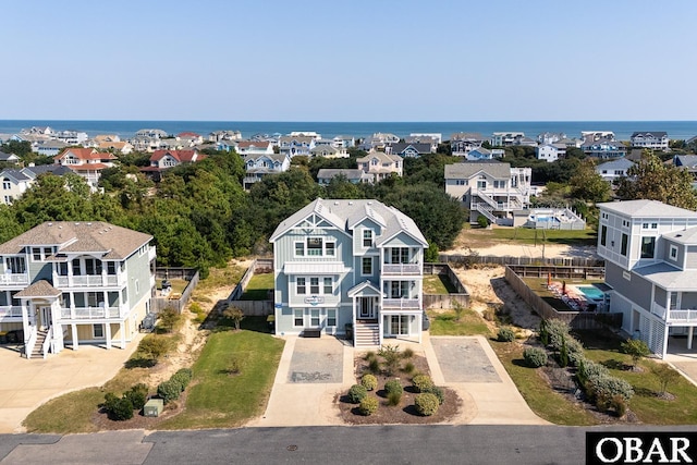 bird's eye view featuring a water view and a residential view