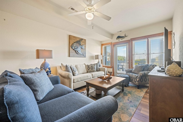 living area featuring a ceiling fan, visible vents, and wood finished floors