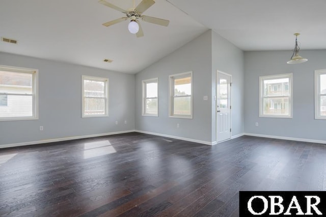 interior space with dark wood-style flooring, a ceiling fan, visible vents, vaulted ceiling, and baseboards