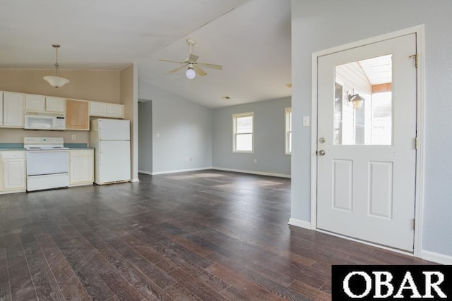 interior space with ceiling fan, dark wood finished floors, lofted ceiling, and baseboards