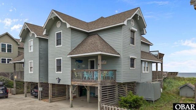 26 Pelican Watch Way Unit 2, Southern Shores, NC 27949 - view of front of house with a shingled roof, a carport, and a wooden deck