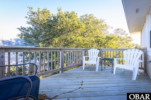 wooden deck featuring visible vents