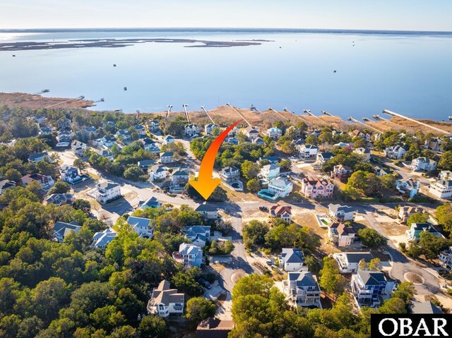 birds eye view of property with a water view and a residential view