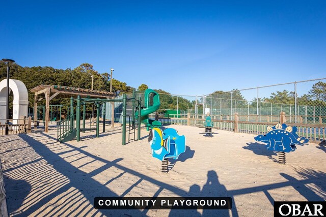 community jungle gym featuring fence