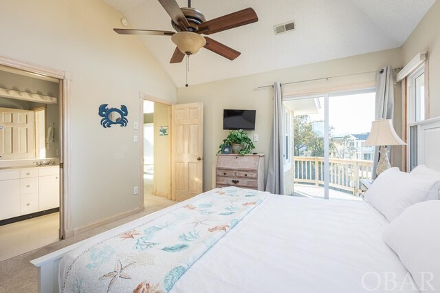 bedroom featuring access to exterior, lofted ceiling, visible vents, light carpet, and ensuite bath