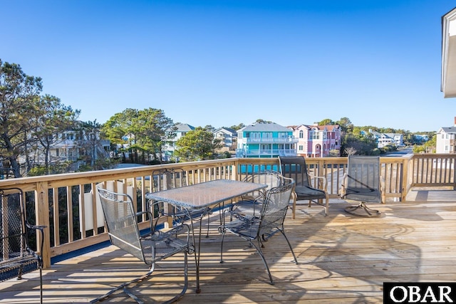 deck with a residential view and outdoor dining area