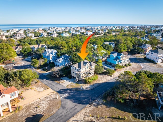 drone / aerial view featuring a water view and a residential view