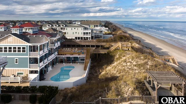 aerial view with a view of the beach, a water view, and a residential view