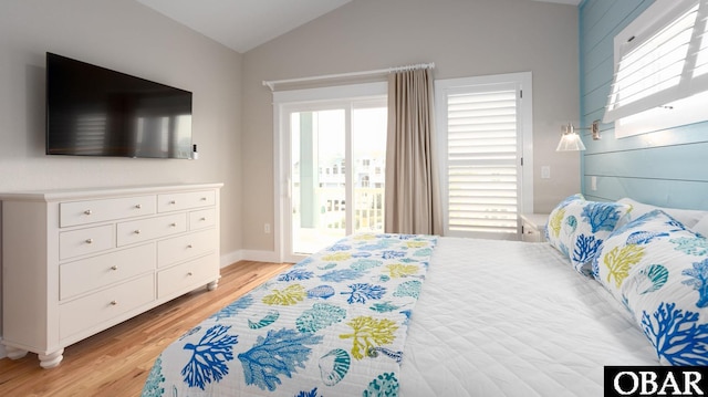 bedroom featuring vaulted ceiling, light wood-type flooring, and access to exterior