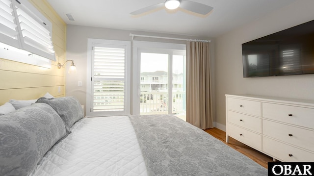 bedroom featuring ceiling fan, visible vents, and wood finished floors