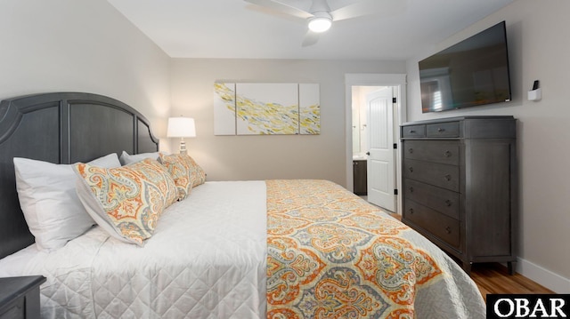 bedroom featuring ceiling fan, baseboards, and wood finished floors