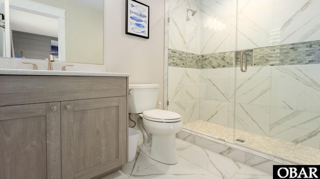 bathroom featuring marble finish floor, a shower stall, toilet, and vanity