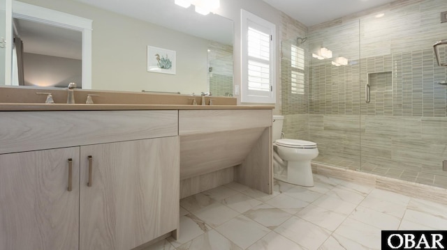 bathroom with marble finish floor, double vanity, a shower stall, and toilet