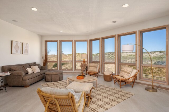 living room featuring light wood-style floors, a wealth of natural light, and recessed lighting