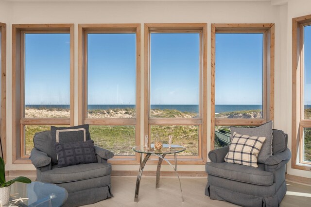 sunroom / solarium featuring a water view