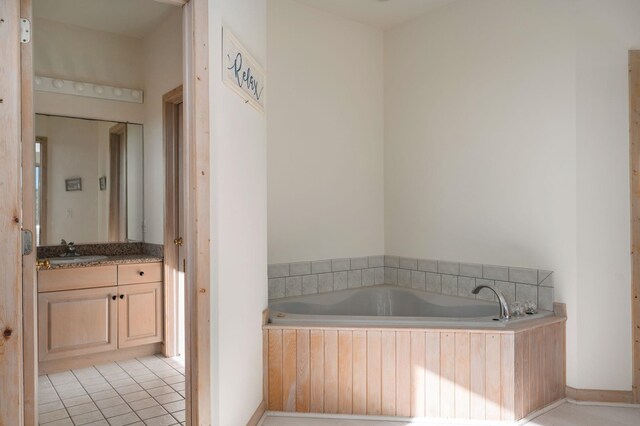 full bath with a bath, vanity, and tile patterned floors