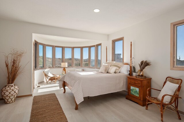 bedroom featuring light wood-style flooring and recessed lighting