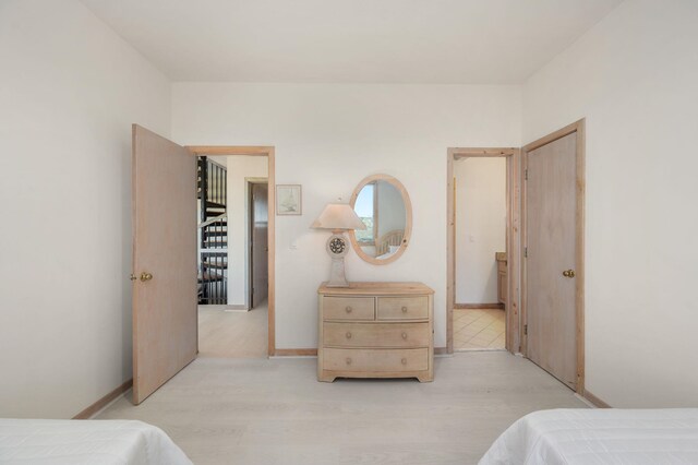 bedroom with baseboards and light wood-style floors