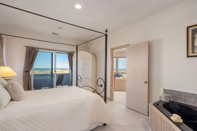 bedroom featuring access to outside, a water view, visible vents, and recessed lighting