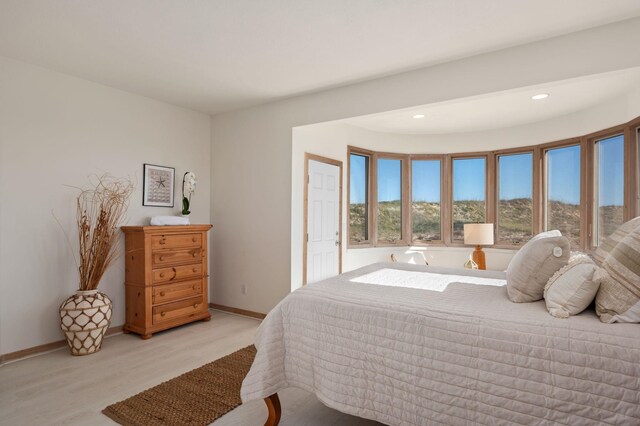 bedroom with light wood-style floors, recessed lighting, and baseboards