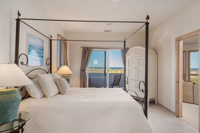 bedroom featuring visible vents, multiple windows, light colored carpet, and access to exterior