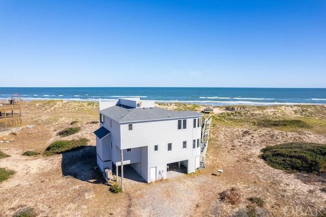 bird's eye view featuring a water view and a beach view