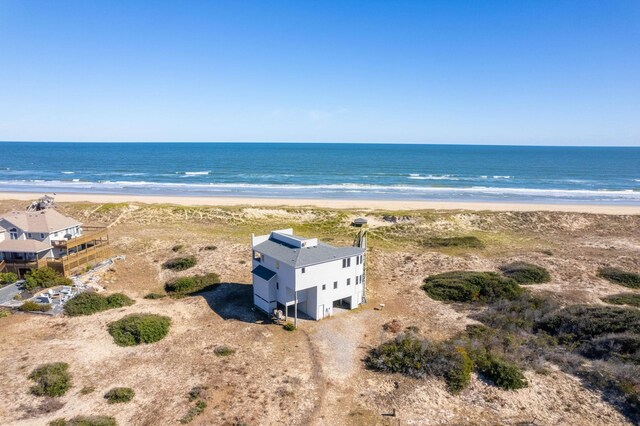 drone / aerial view featuring a view of the beach and a water view