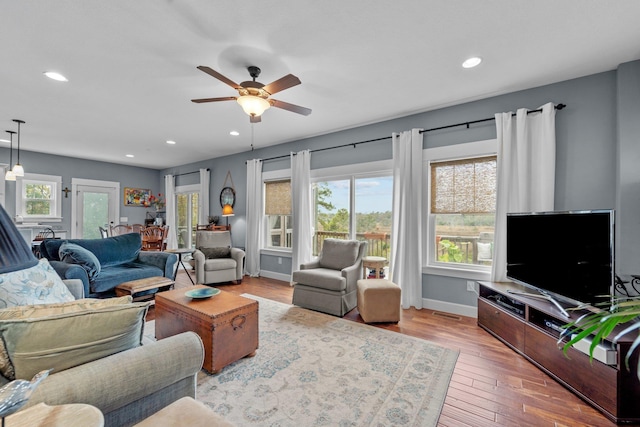 living room with ceiling fan, recessed lighting, wood finished floors, and baseboards