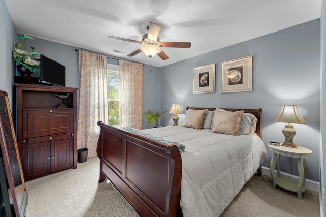 bedroom with baseboards, visible vents, a ceiling fan, and light colored carpet