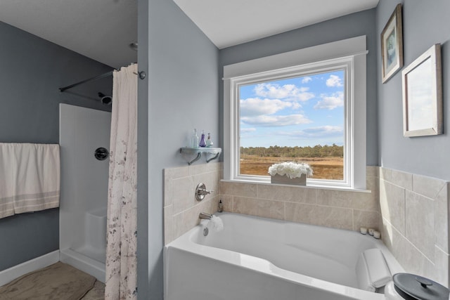 bathroom featuring a stall shower and a garden tub