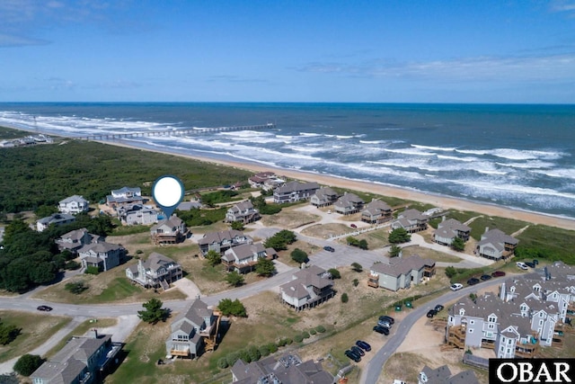 birds eye view of property with a water view, a residential view, and a beach view