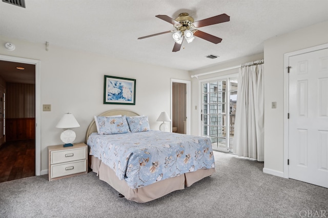 carpeted bedroom featuring baseboards, a ceiling fan, visible vents, and access to exterior