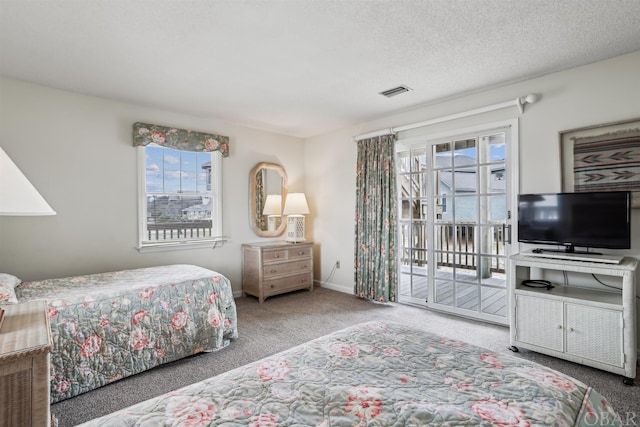 bedroom featuring access to exterior, visible vents, carpet flooring, a textured ceiling, and baseboards