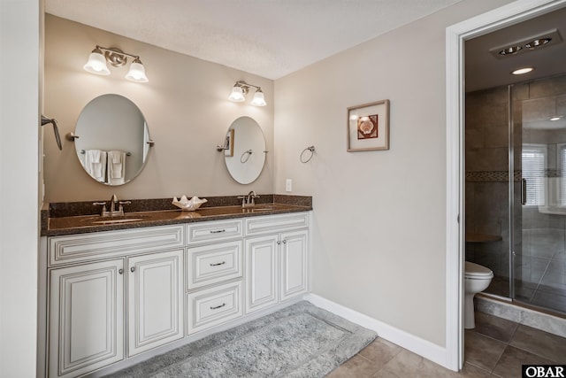 bathroom with tile patterned floors, a sink, toilet, and baseboards