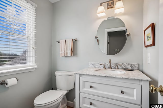 bathroom featuring toilet and vanity