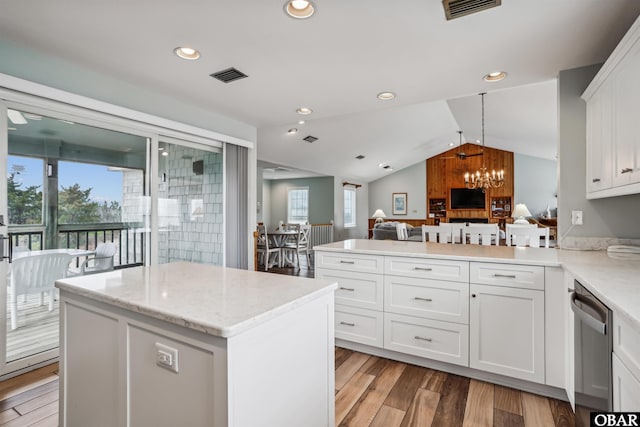 kitchen with visible vents, open floor plan, white cabinetry, light wood-type flooring, and dishwasher