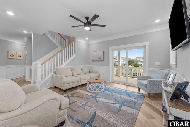 1207 Tail Wind Ct Lot 267, Corolla, NC 27927 - living room featuring ornamental molding, ceiling fan, stairway, wood finished floors, and wainscoting