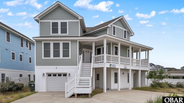 1207 Tail Wind Ct Lot 267, Corolla, NC 27927 - view of front of property featuring covered porch, concrete driveway, a garage, stairs, and a shingled roof