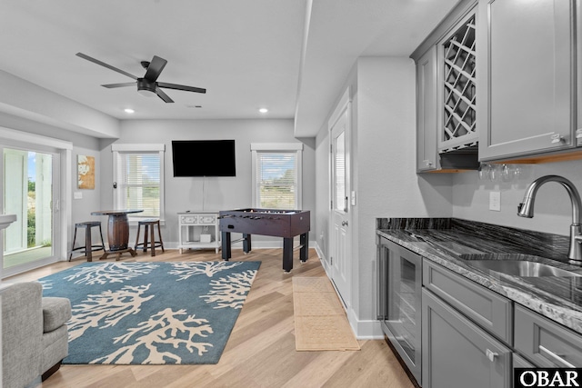 1207 Tail Wind Ct Lot 267, Corolla, NC 27927 - kitchen featuring gray cabinetry, a sink, light wood-style flooring, dark stone countertops, and recessed lighting