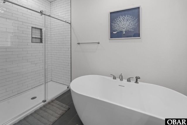1207 Tail Wind Ct Lot 267, Corolla, NC 27927 - bathroom with a freestanding bath, a shower stall, and tile patterned flooring