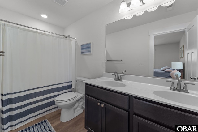1207 Tail Wind Ct Lot 267, Corolla, NC 27927 - full bath with double vanity, wood finished floors, toilet, and curtained shower