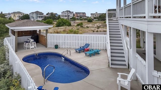 1207 Tail Wind Ct Lot 267, Corolla, NC 27927 - view of swimming pool with a patio area, a fenced backyard, stairway, and a residential view